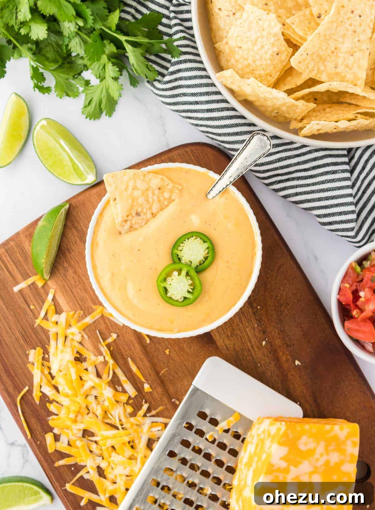 5-Minute Creamy Nacho Cheese Dip 14 A rustic ceramic bowl brimming with rich nacho cheese sauce, beautifully garnished with vibrant green jalapeño slices, ready for dipping.