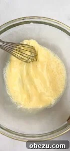 Mixing wet ingredients for corn fritters.