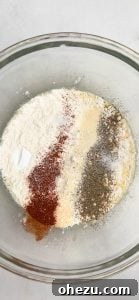Adding dry ingredients to the wet mixture.