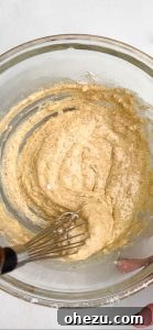 Folding corn and cheese into the fritter batter.