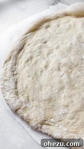 Naples' Authentic Pizza Masterpiece 15 Pizza dough on a wooden peel, ready for toppings