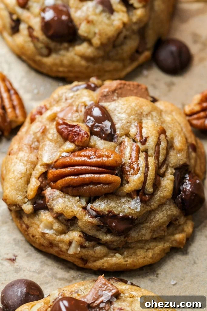 Liqueur Spiked Brown Butter Pecan Cookies 4 Close-up of baked brown butter pecan cookies with visible pecans and chocolate