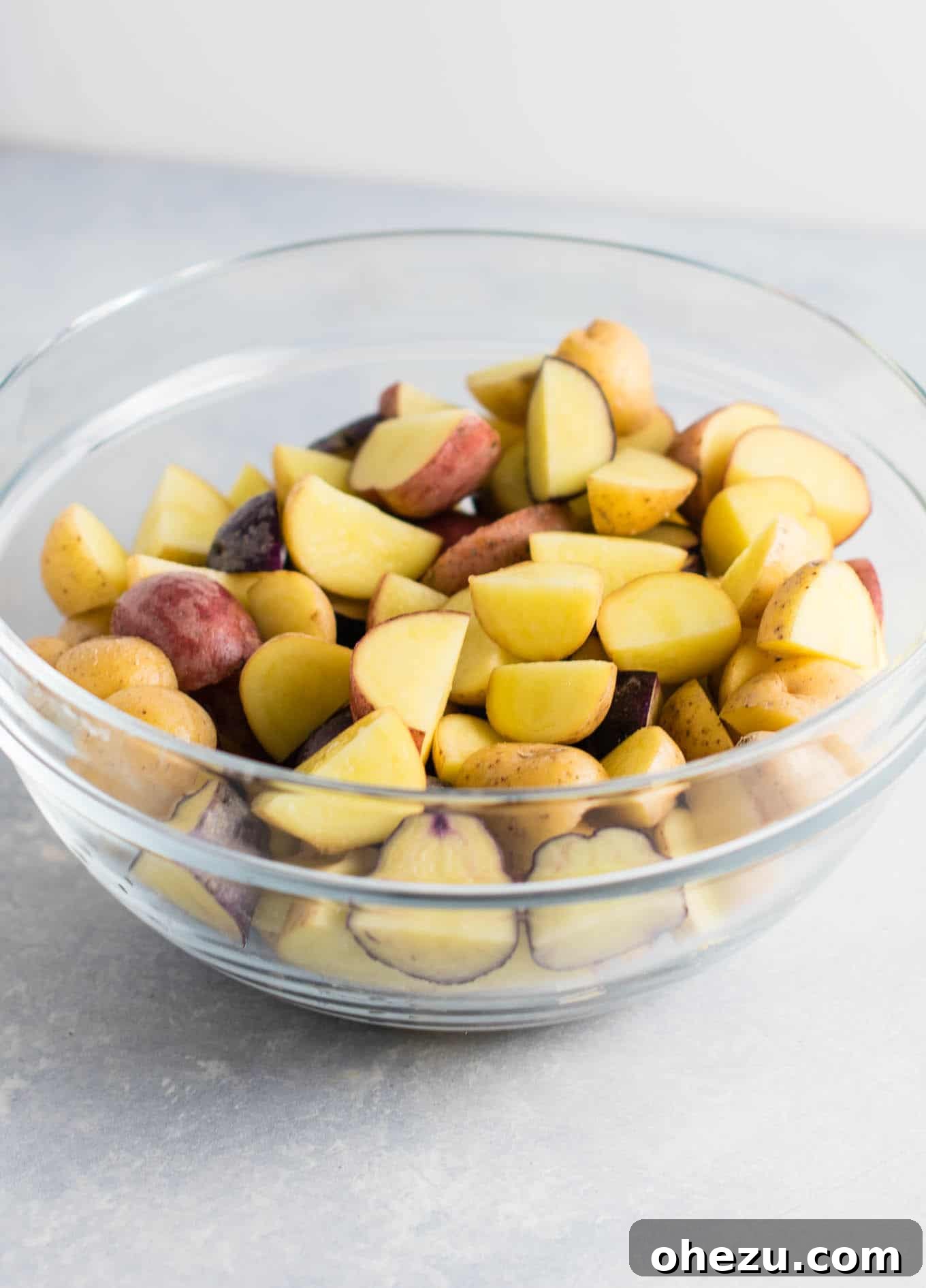 Close-up of golden garlic parmesan roasted potatoes in a bowl, showcasing their irresistible crispiness.