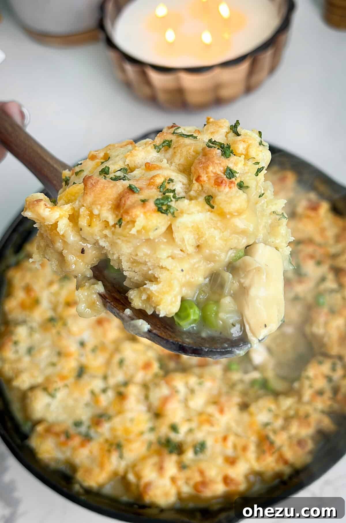 Savory Chicken Pot Pie Crowned with Cheddar Bay Biscuits 3 Close-up view of a baked chicken pot pie with biscuits in a cast iron skillet.