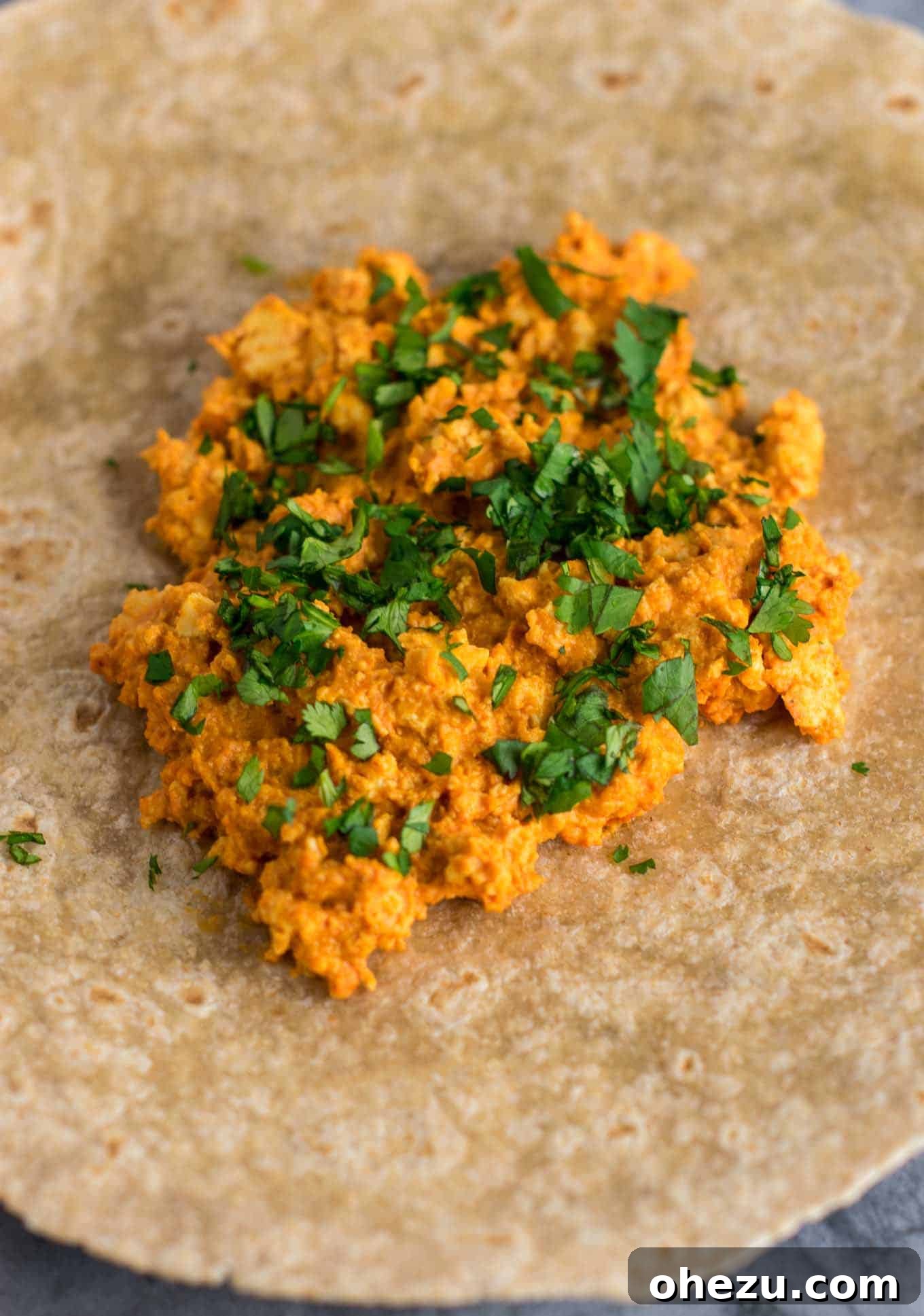 Scrambled tofu cooking in the rich, cheesy cashew sauce