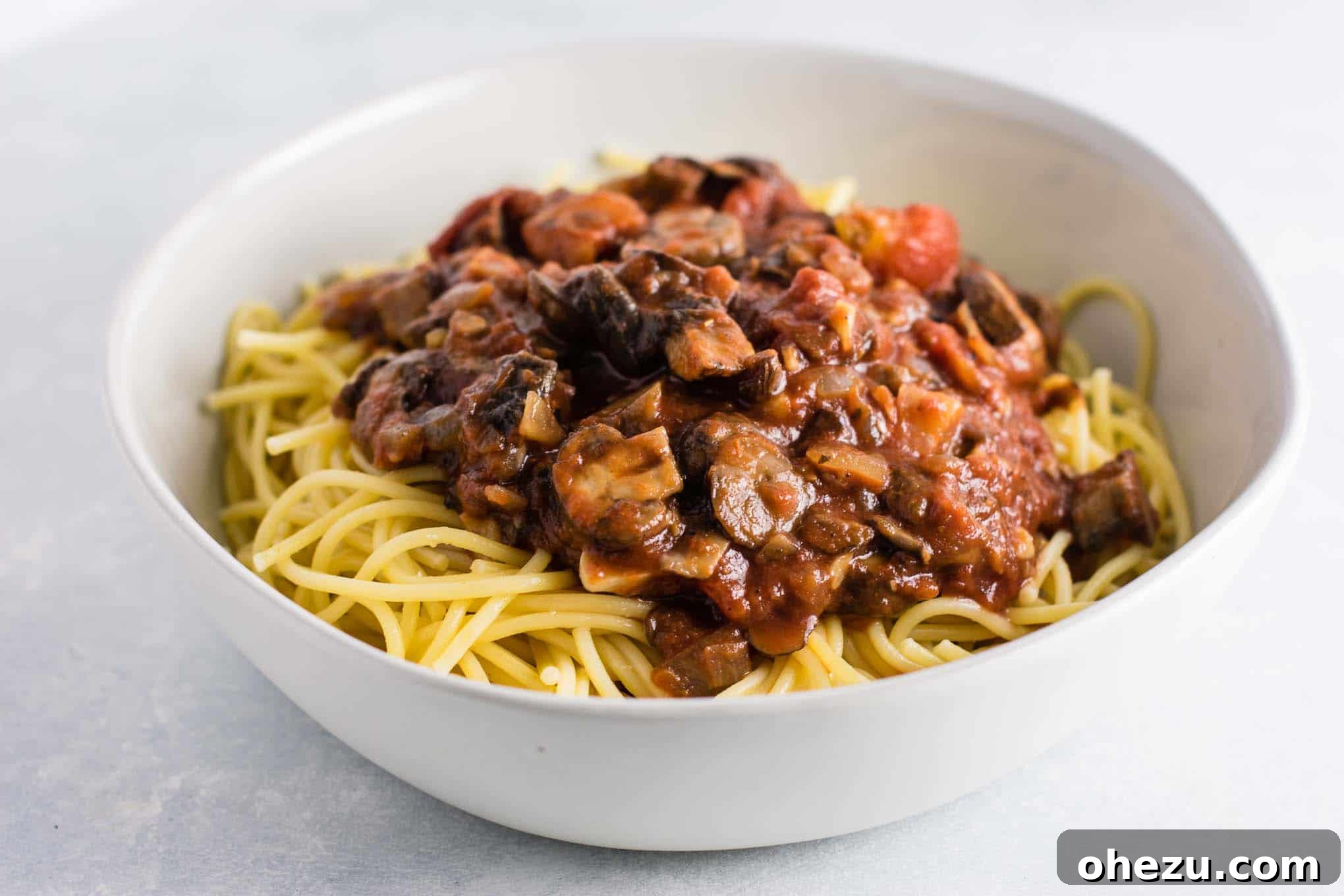 A bowl of meatless spaghetti sauce over pasta, showcasing the rich texture and inviting appearance, perfect for a satisfying meal.