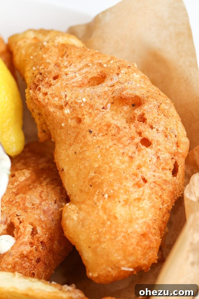 Crispy fish and chips with lemon wedges and dipping sauces