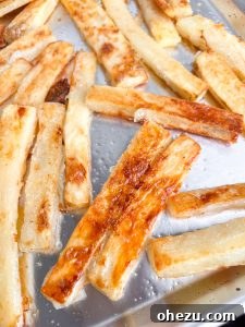 Golden crispy oven fries on a baking sheet