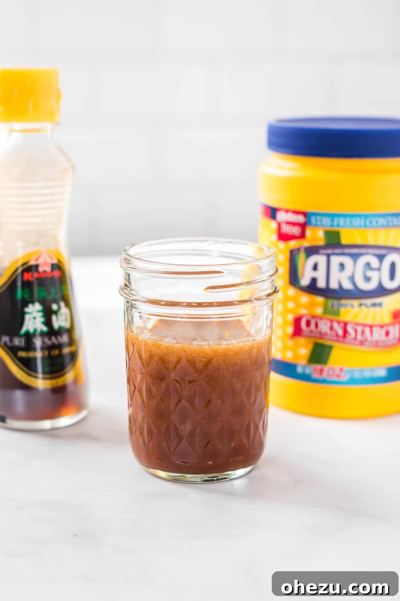 Gourmet Stir Fry Sauce 11 Stir fry sauce in a jar with sesame oil and corn starch bottles in the background