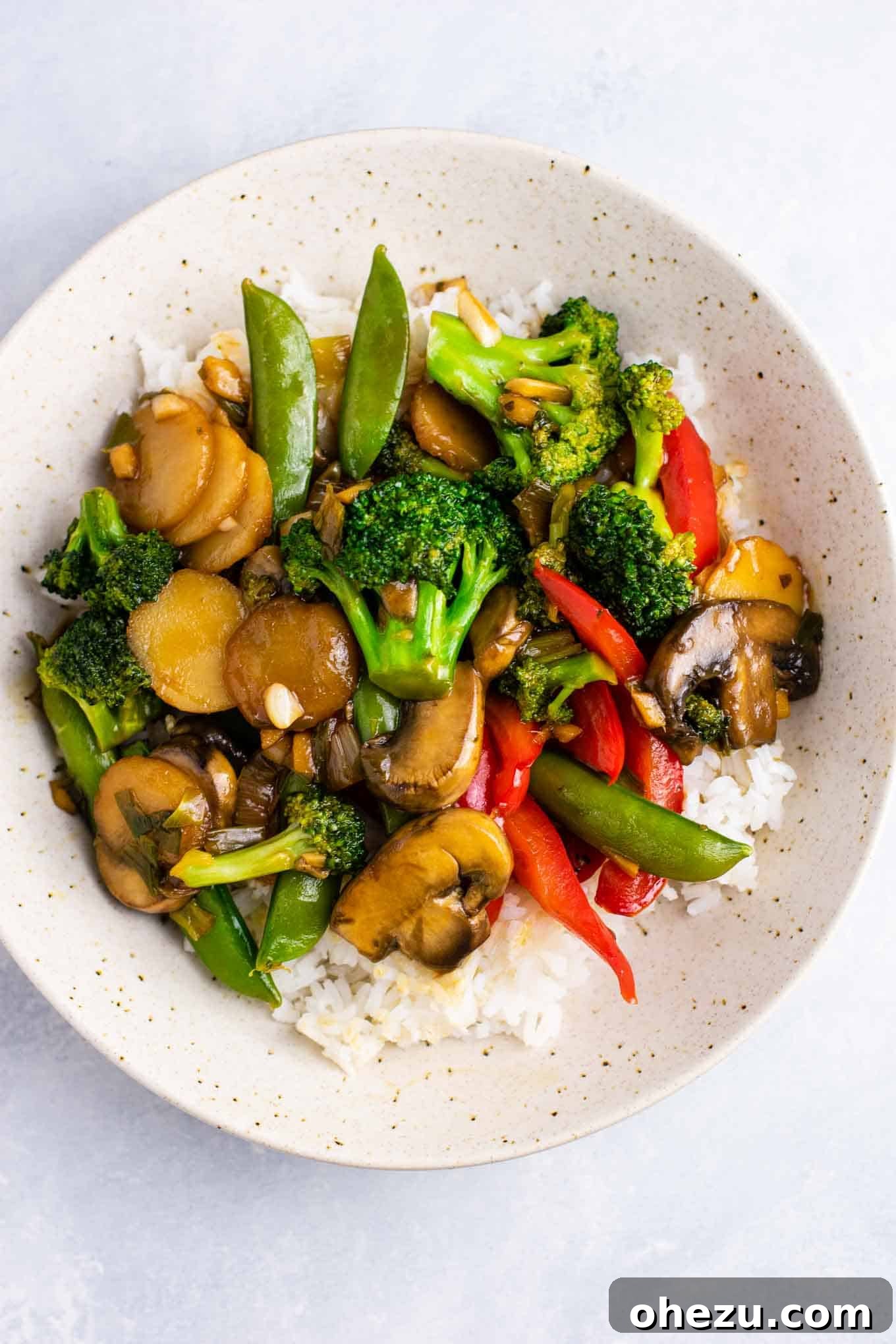 Gourmet Stir Fry Sauce 5 A vibrant bowl of stir fry vegetables over white rice, perfectly coated in sauce