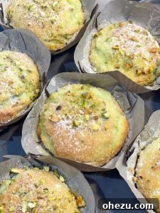Easy Bakery-Style Pistachio Muffins with green pistachios