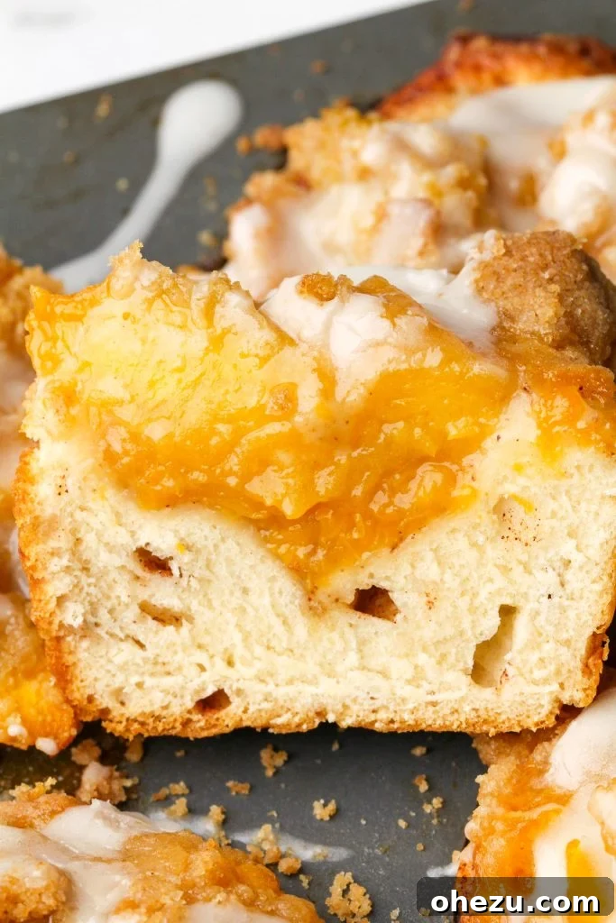 Various ingredients for peach cobbler cinnamon rolls laid out on a kitchen counter