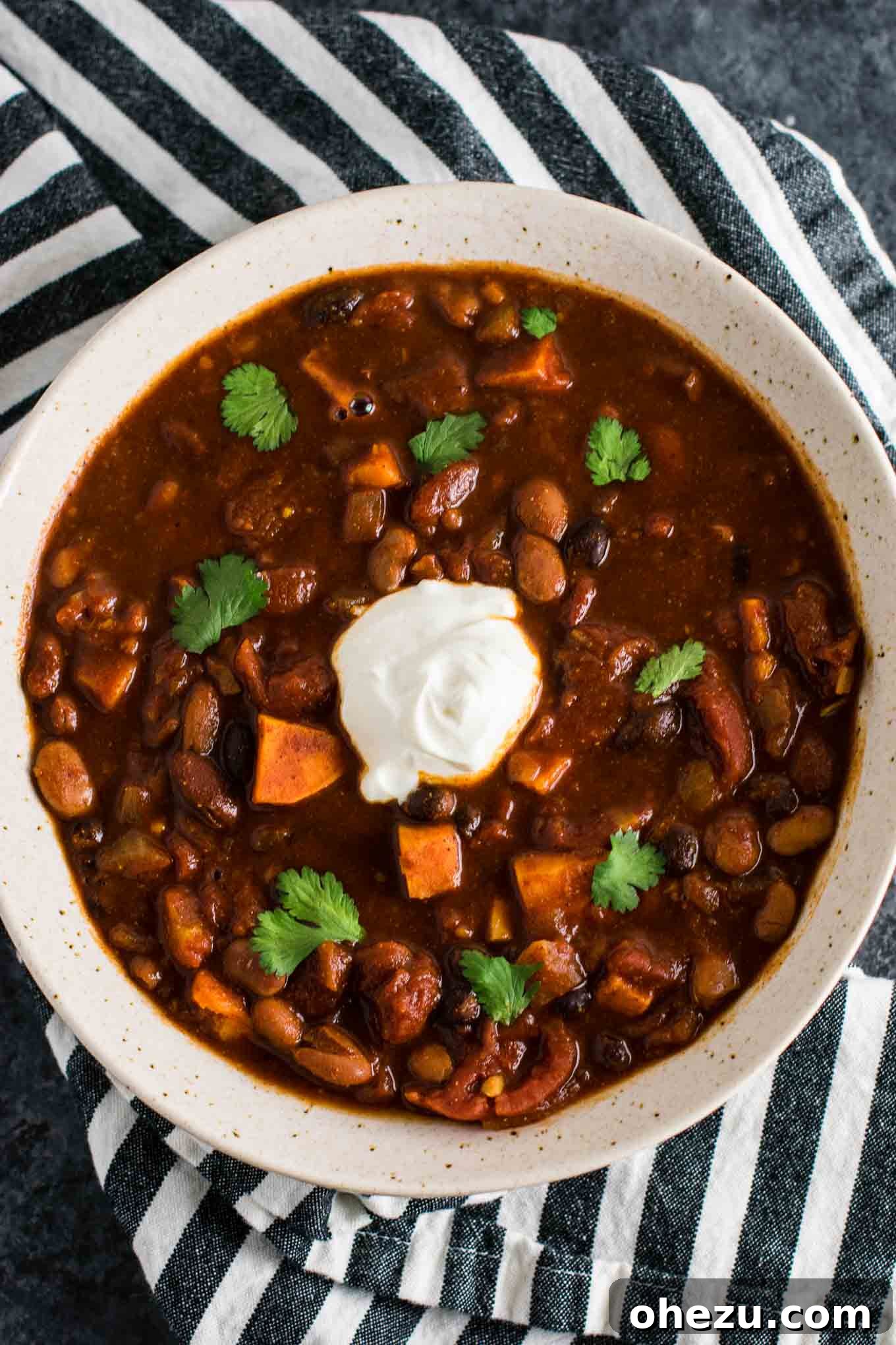Effortless Plant-Based Sweet Potato Chili in Your Slow Cooker 11 A steaming bowl of slow cooker vegetarian sweet potato chili, emphasizing its rich texture and appetizing appearance, promising a satisfying, meat-free meal.