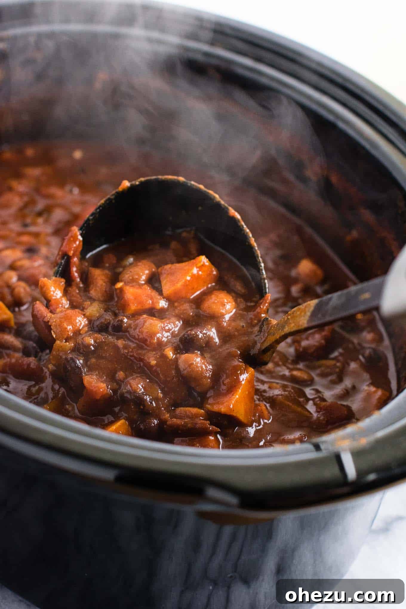 Effortless Plant-Based Sweet Potato Chili in Your Slow Cooker 12 An overhead shot of a table setting featuring a bowl of slow cooker vegetarian sweet potato chili, surrounded by fresh toppings and a rustic napkin, inviting diners to enjoy.