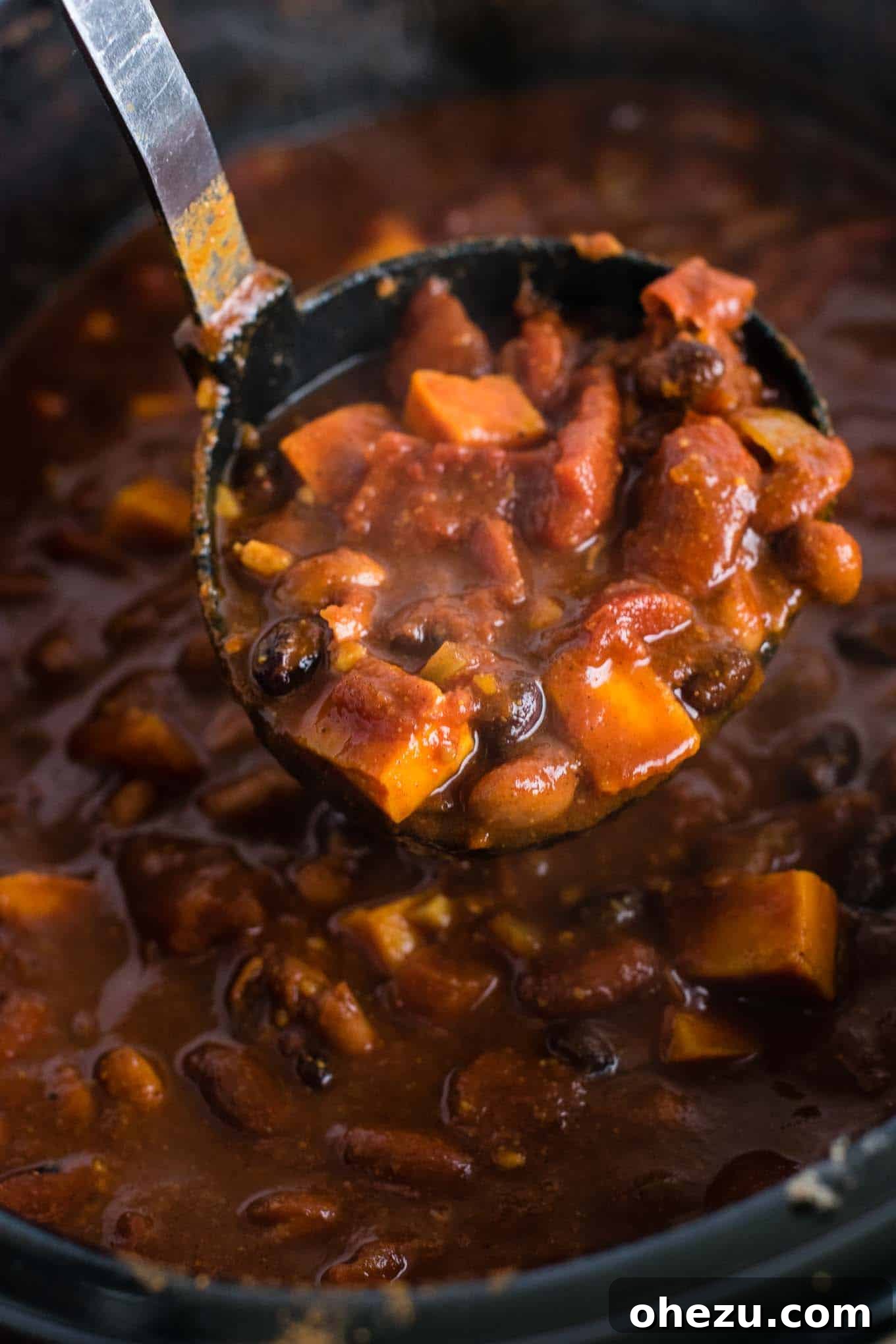 Effortless Plant-Based Sweet Potato Chili in Your Slow Cooker 13 A beautifully presented bowl of slow cooker vegetarian sweet potato chili, garnished with vibrant toppings, captured from a slightly elevated angle, inviting viewers to cook and enjoy.