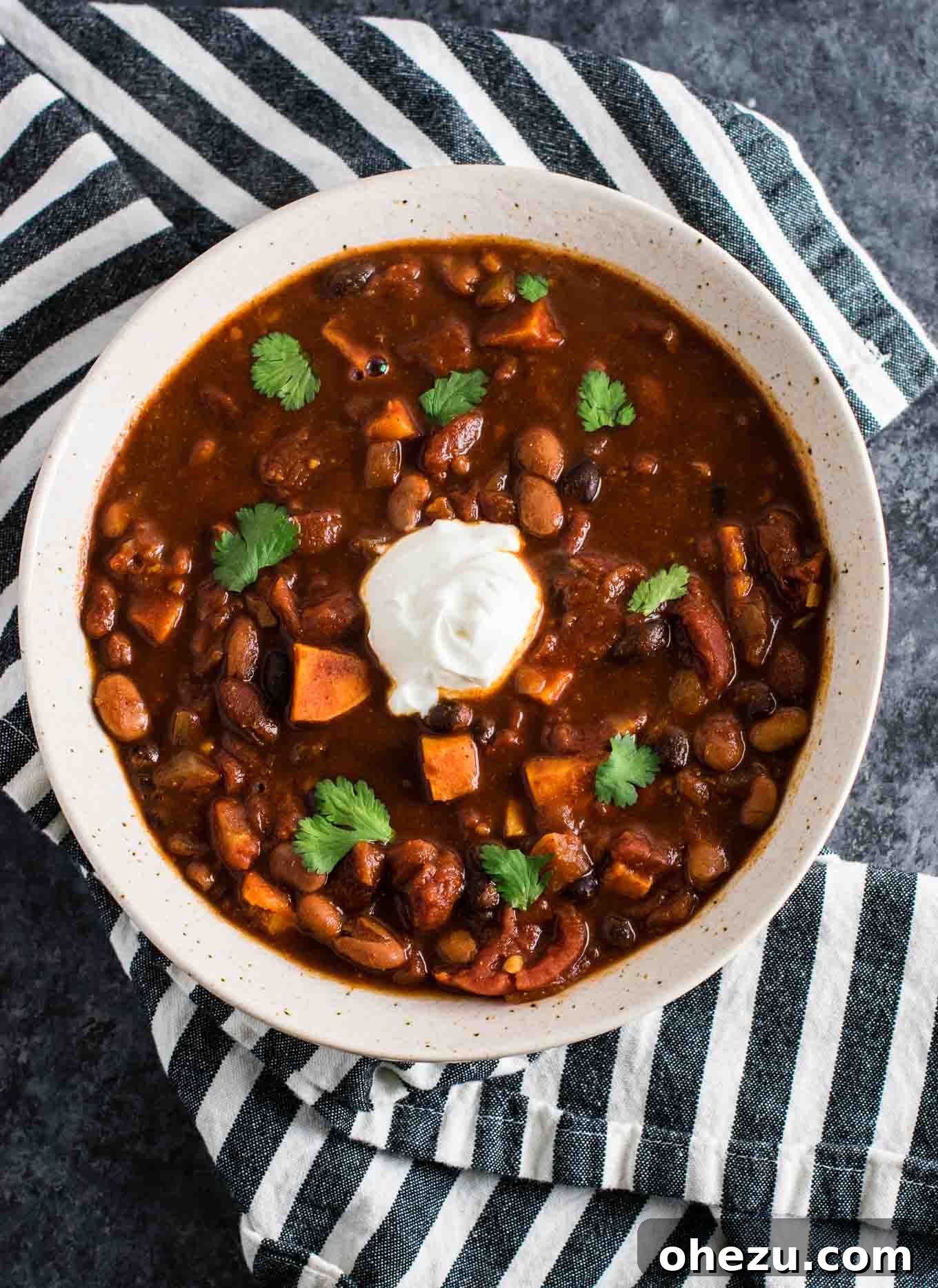 Effortless Plant-Based Sweet Potato Chili in Your Slow Cooker 7 A large pot of slow cooker vegetarian sweet potato chili, steaming hot and ready to be served, showing its rich, thick consistency.