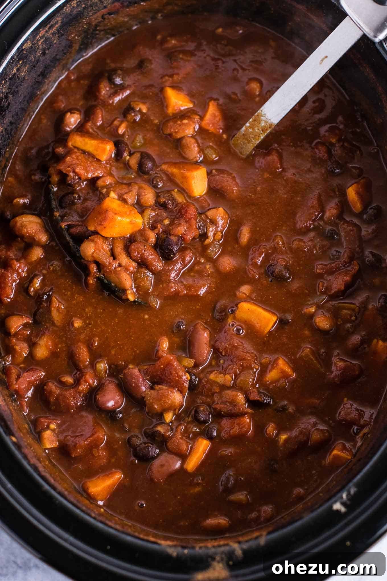 Effortless Plant-Based Sweet Potato Chili in Your Slow Cooker 9 A close-up shot of a bowl of vegetarian sweet potato chili with corn chips on the side, highlighting the perfect pairing of crunchy and hearty.