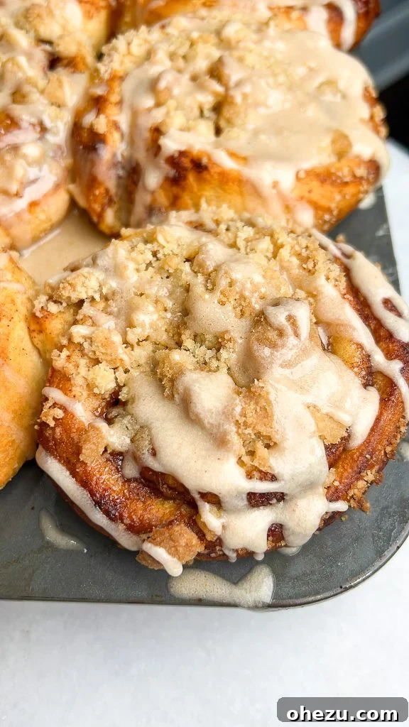 Close-up of golden brown apple pie cinnamon rolls baked in a muffin tin