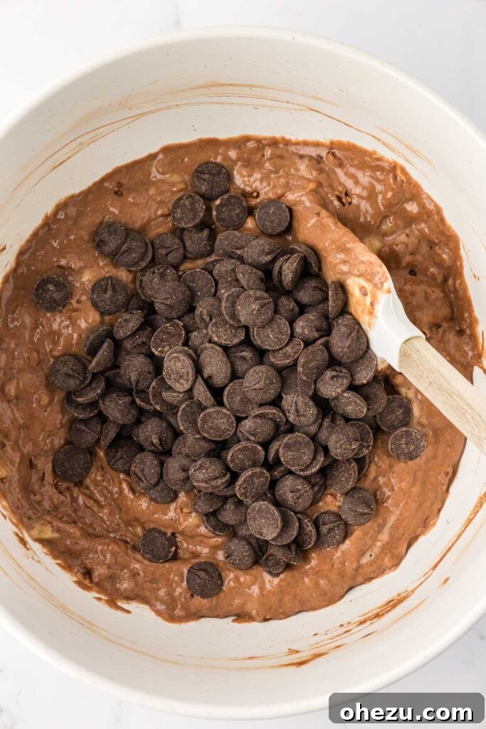 adding the chocolate chips to the muffin batter