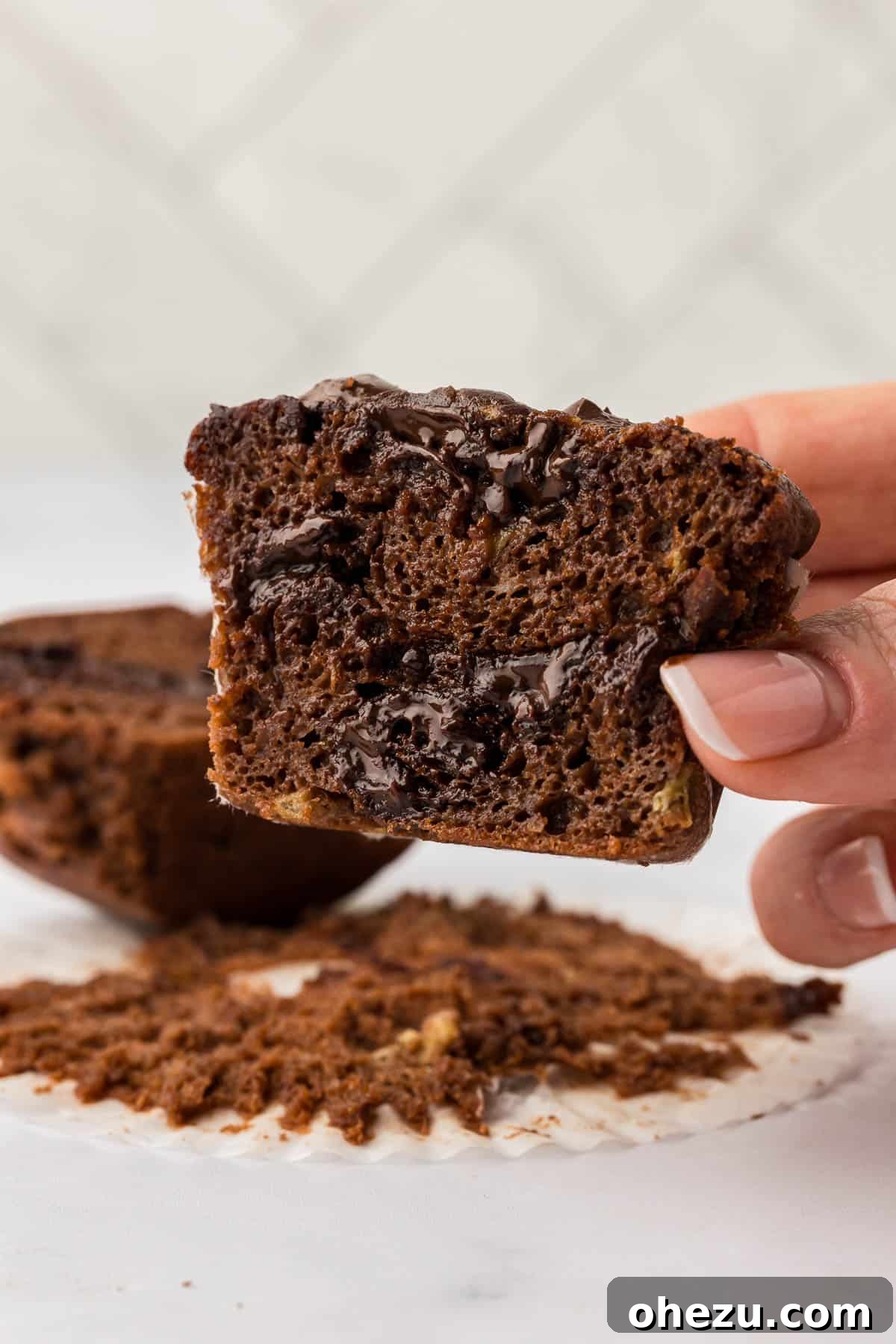 holding a muffin cut open to show the inside texture