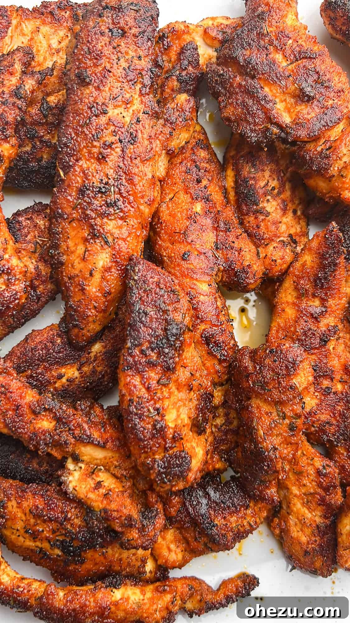 Sweet & Tangy Honey Mustard Chicken BLT Sliders 4 Step-by-step image of seasoning chicken tenders for sliders
