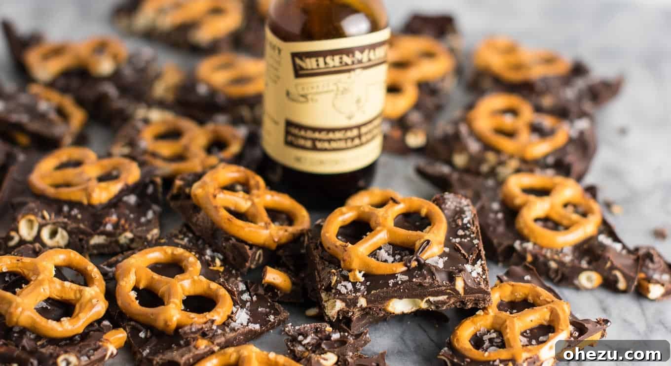 Vegan Sweet & Salty Chocolate Pretzel Bark 10 Finished Vegan Chocolate Sea Salt Pretzel Bark, ready to be frozen, with whole pretzels and sea salt flakes visible on top.