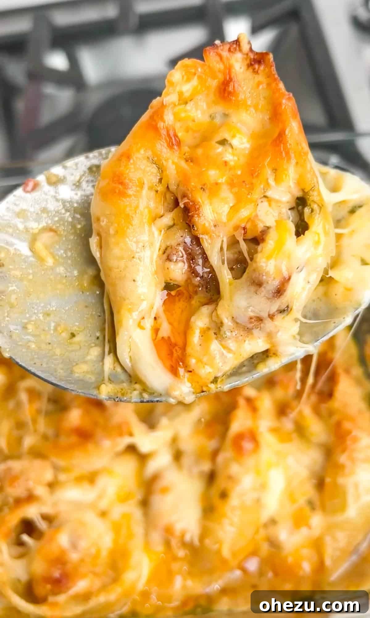 Close-up of baked chicken scampi stuffed shells with melted cheese