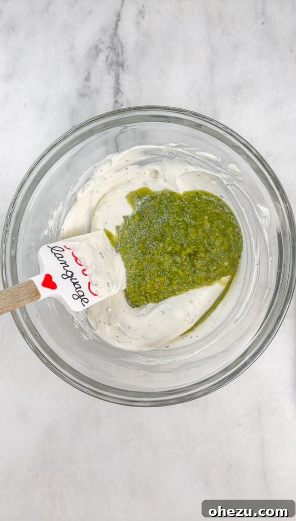 Step-by-step image of blending cilantro and pickled jalapenos for the vibrant verde sauce