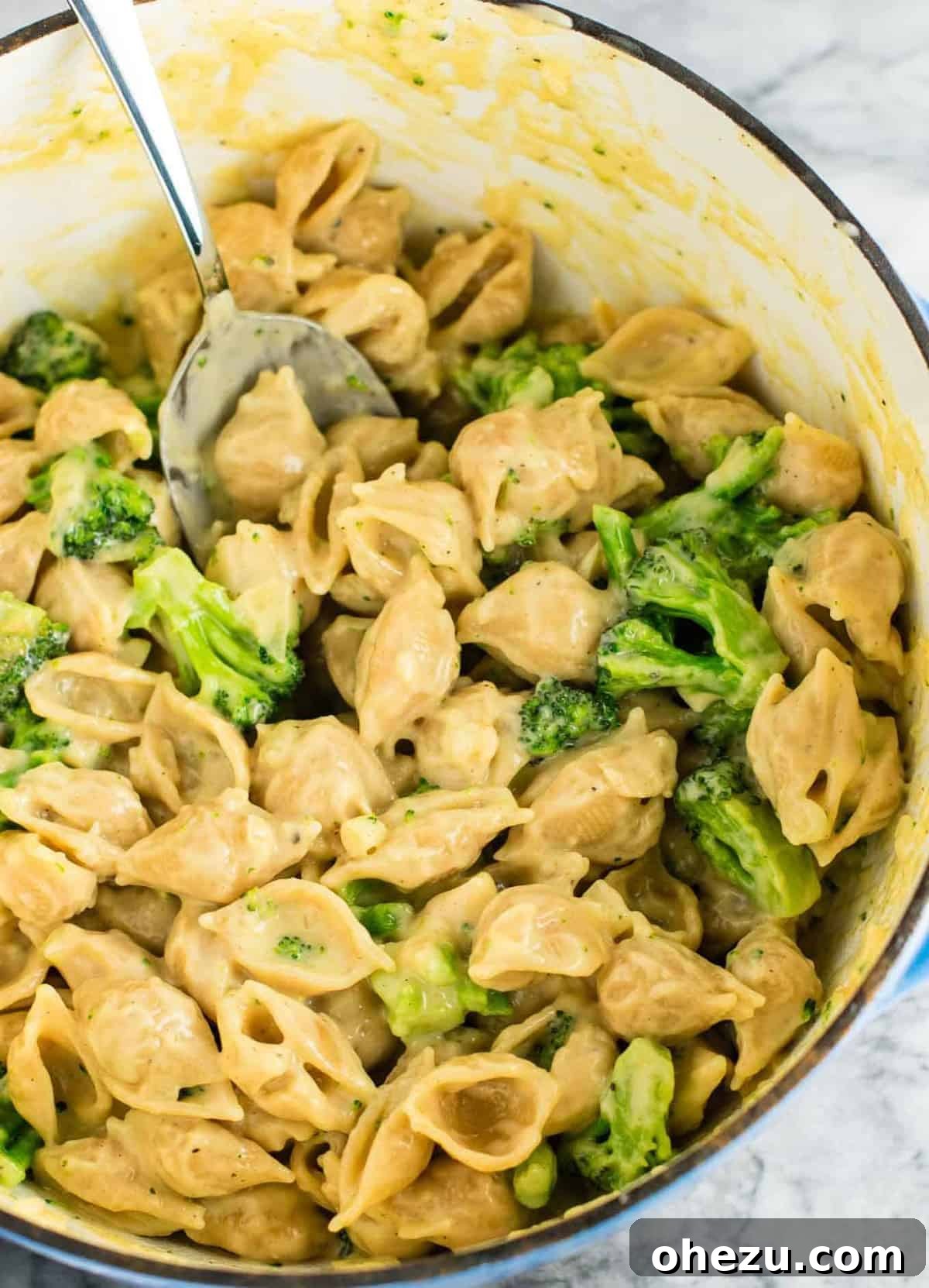 Lightened up broccoli mac and cheese with sharp cheddar cheese and whole wheat pasta. The healthiest way to justify eating macaroni and cheese for dinner. Kids will love this one! #broccolishellsandcheese #macandcheese #healthy #dinner #vegetarian #meatless #pasta #wholewheat
