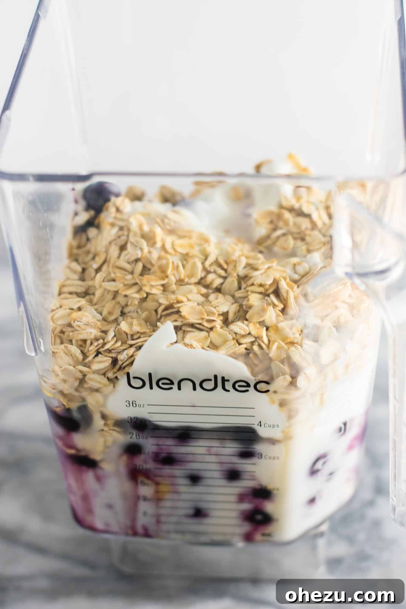 Close-up shot of the blueberry pie smoothie, emphasizing the rich, natural purple hue from the berries. The glass is sweat-kissed, indicating its refreshing coldness. #healthy #blueberrysmoothie #blueberrypiesmoothie #vegetarian #greekyogurt #lemonzest #glutenfree