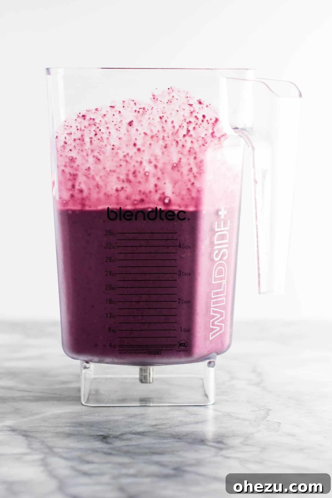 A top-down view of the blueberry pie smoothie, highlighting its inviting appearance. The focus is on the drink itself, showcasing its creamy texture and the vibrant color of blueberries. #healthy #blueberrysmoothie #blueberrypiesmoothie #vegetarian #greekyogurt #lemonzest #glutenfree
