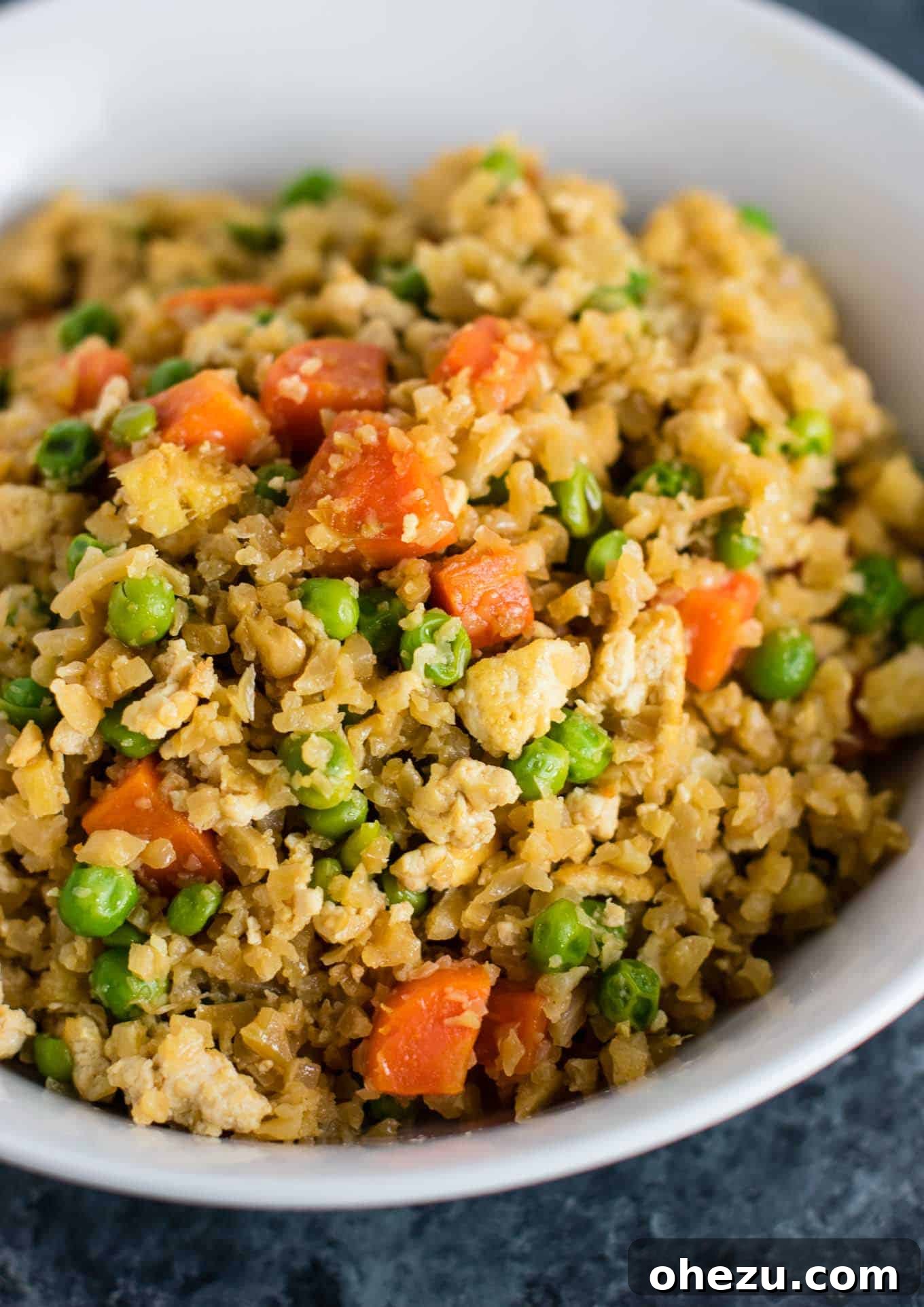 Flavorful Tofu and Cauliflower Rice Stir-Fry 11 This cauliflower tofu fried rice is vegan, gluten free, grain free, and low carb. You won't believe this doesn't have rice or eggs in it! My new favorite dinner recipe! #grainfree #glutenfree #cauliflowerfriedrice #tofufriedrice #vegan #dinner #eggfree