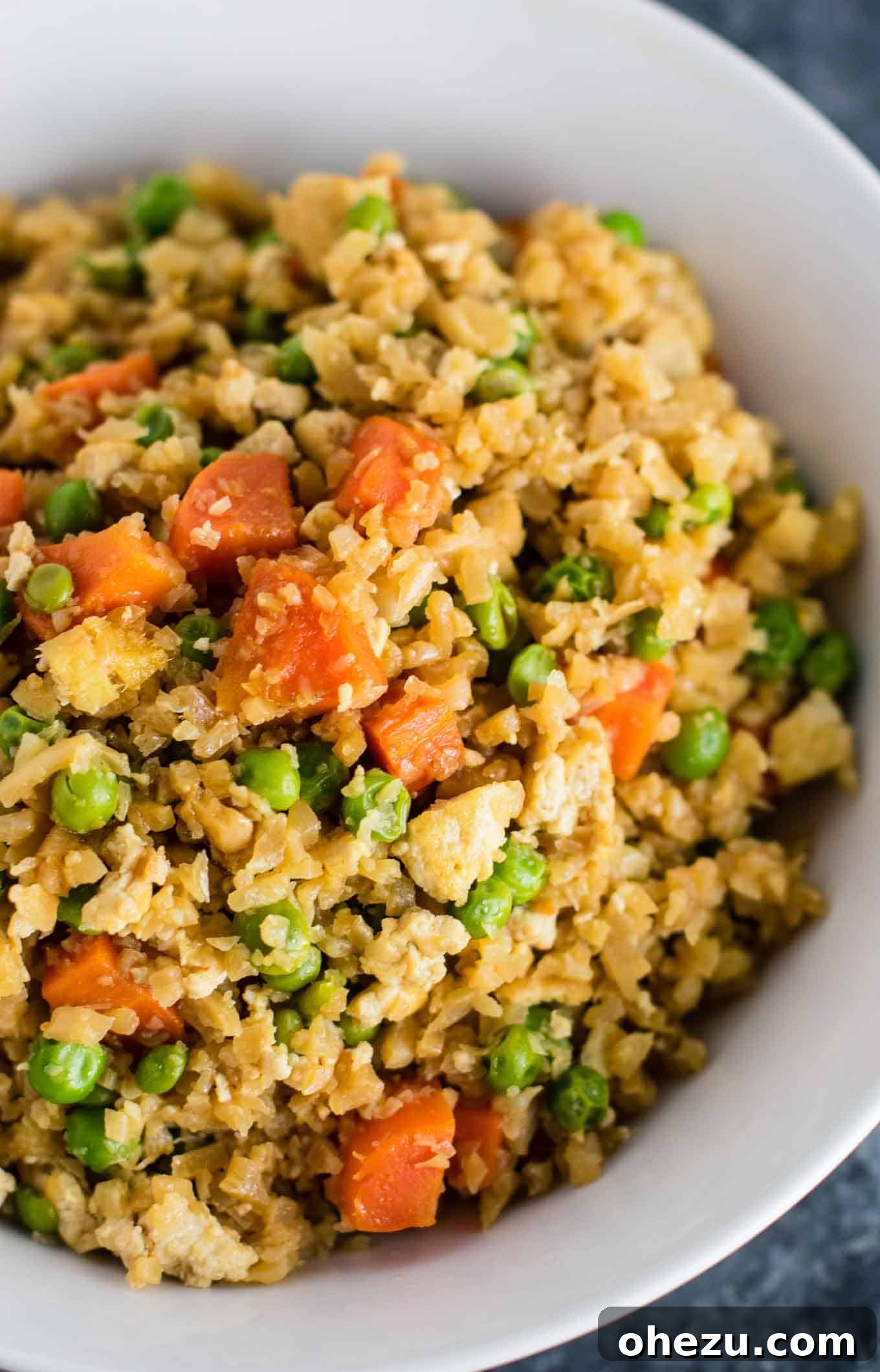Flavorful Tofu and Cauliflower Rice Stir-Fry 9 This cauliflower tofu fried rice is vegan, gluten free, grain free, and low carb. You won't believe this doesn't have rice or eggs in it! My new favorite dinner recipe! #grainfree #glutenfree #cauliflowerfriedrice #tofufriedrice #vegan #dinner #eggfree