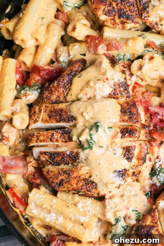 Creamy Tuscan Chicken Pasta with tender chicken, sun-dried tomatoes, and spinach