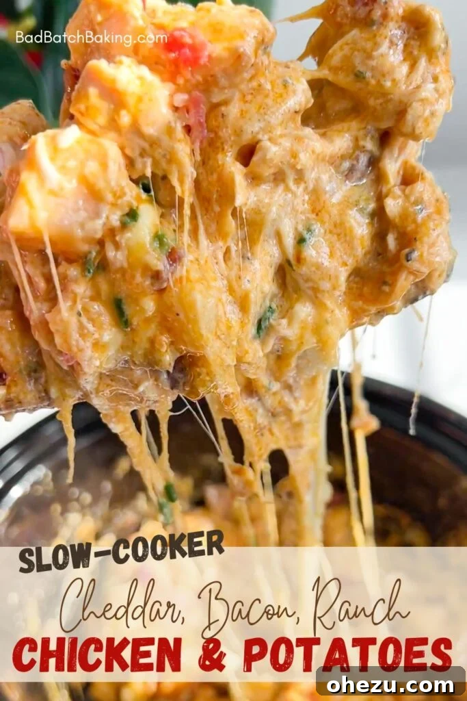 Loaded Slow Cooker Ranch Chicken and Potatoes 5 A serving of Cheesy Bacon Ranch Slow Cooker Chicken and Potatoes in a white bowl with a fork, ready to eat.
