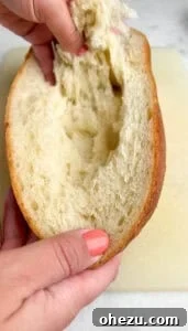 Mid-preparation image of French bread pizza: layering cheese and toppings.