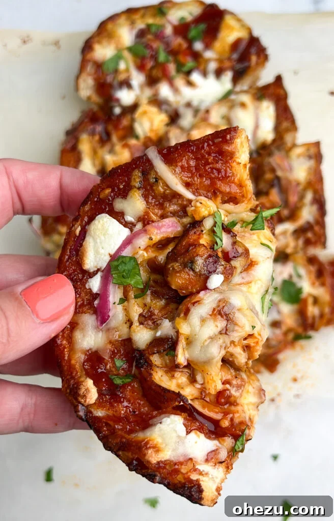 Signature BBQ Chicken French Bread Pizza 8 Freshly baked BBQ Chicken French Bread Pizza, sliced and ready to serve, garnished with cilantro.