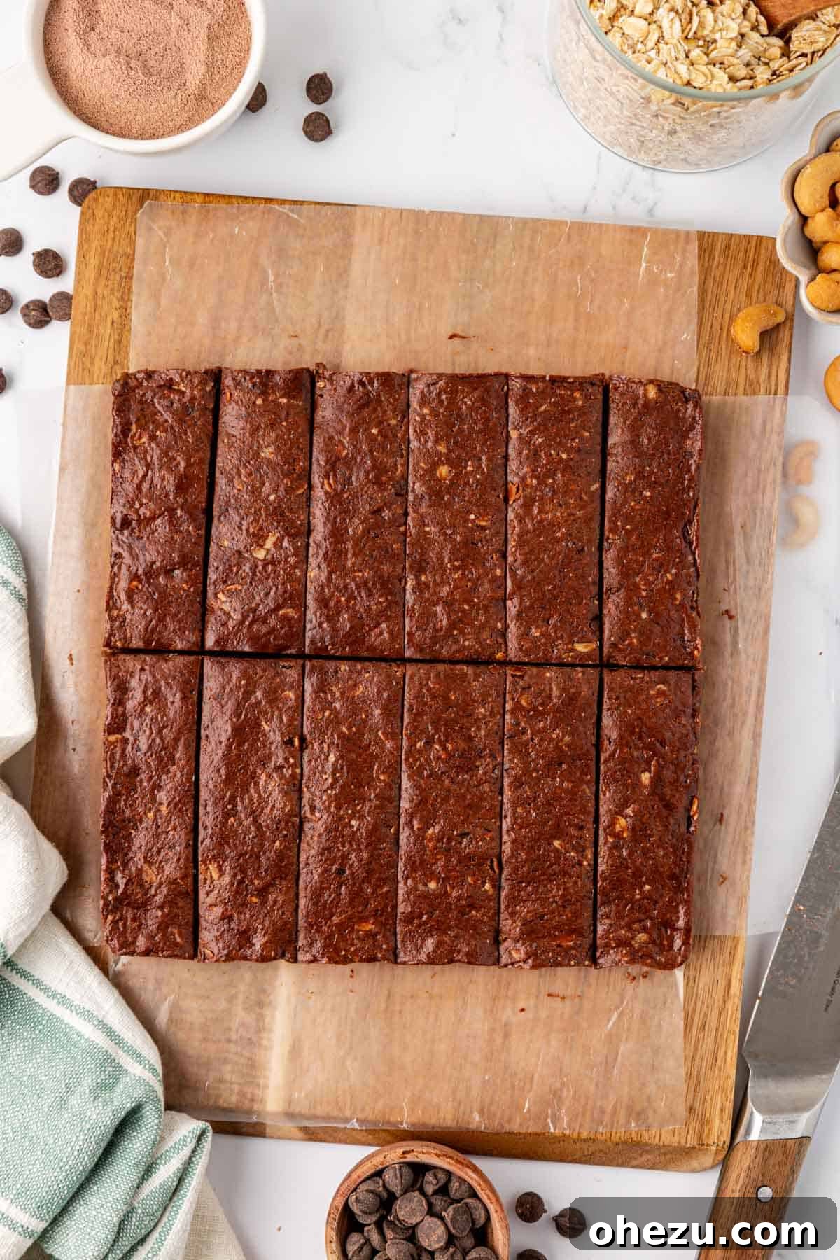 Neatly sliced chocolate cashew protein bars arranged on a cutting board