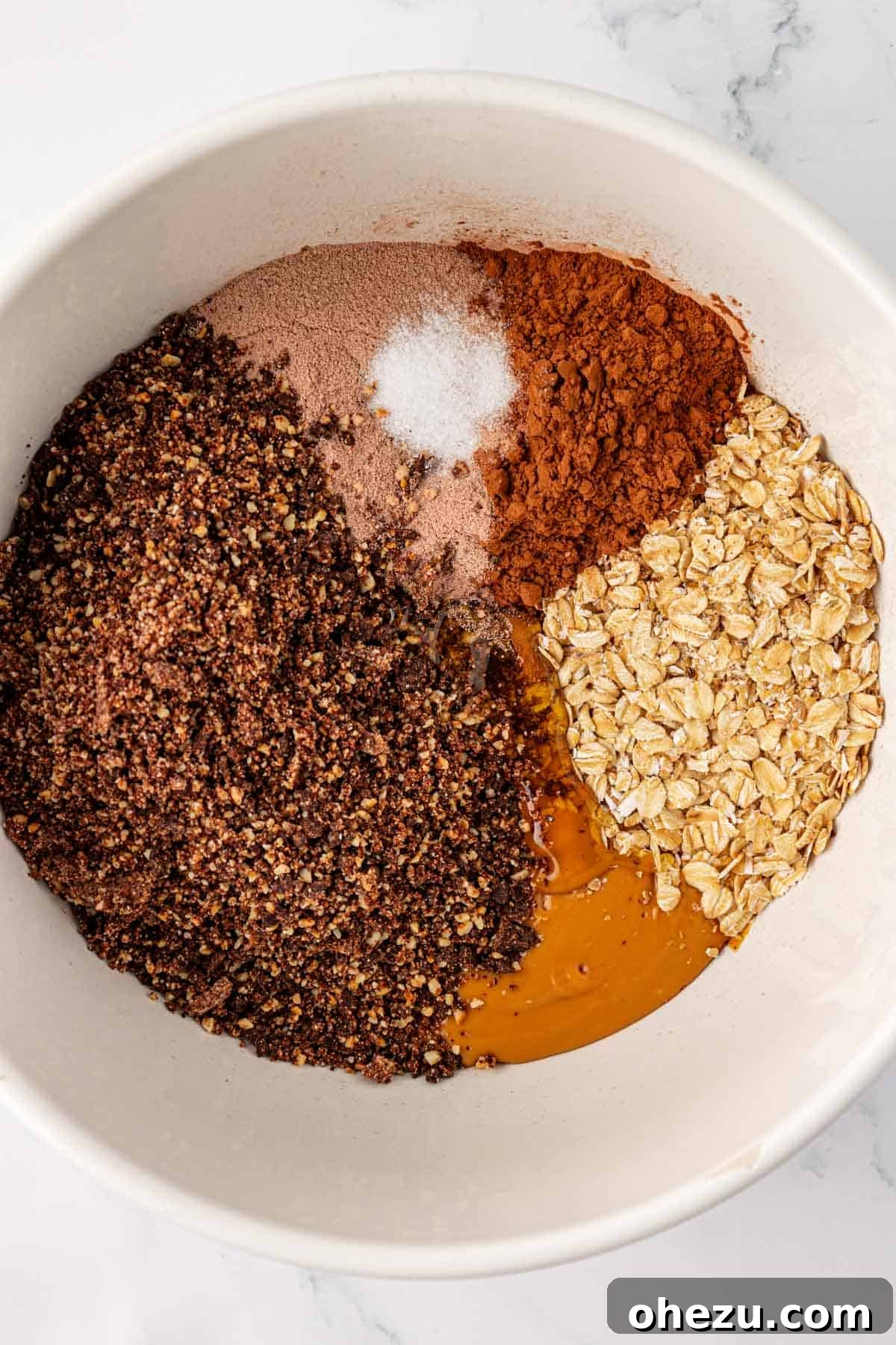 All protein bar ingredients in a large mixing bowl before combining