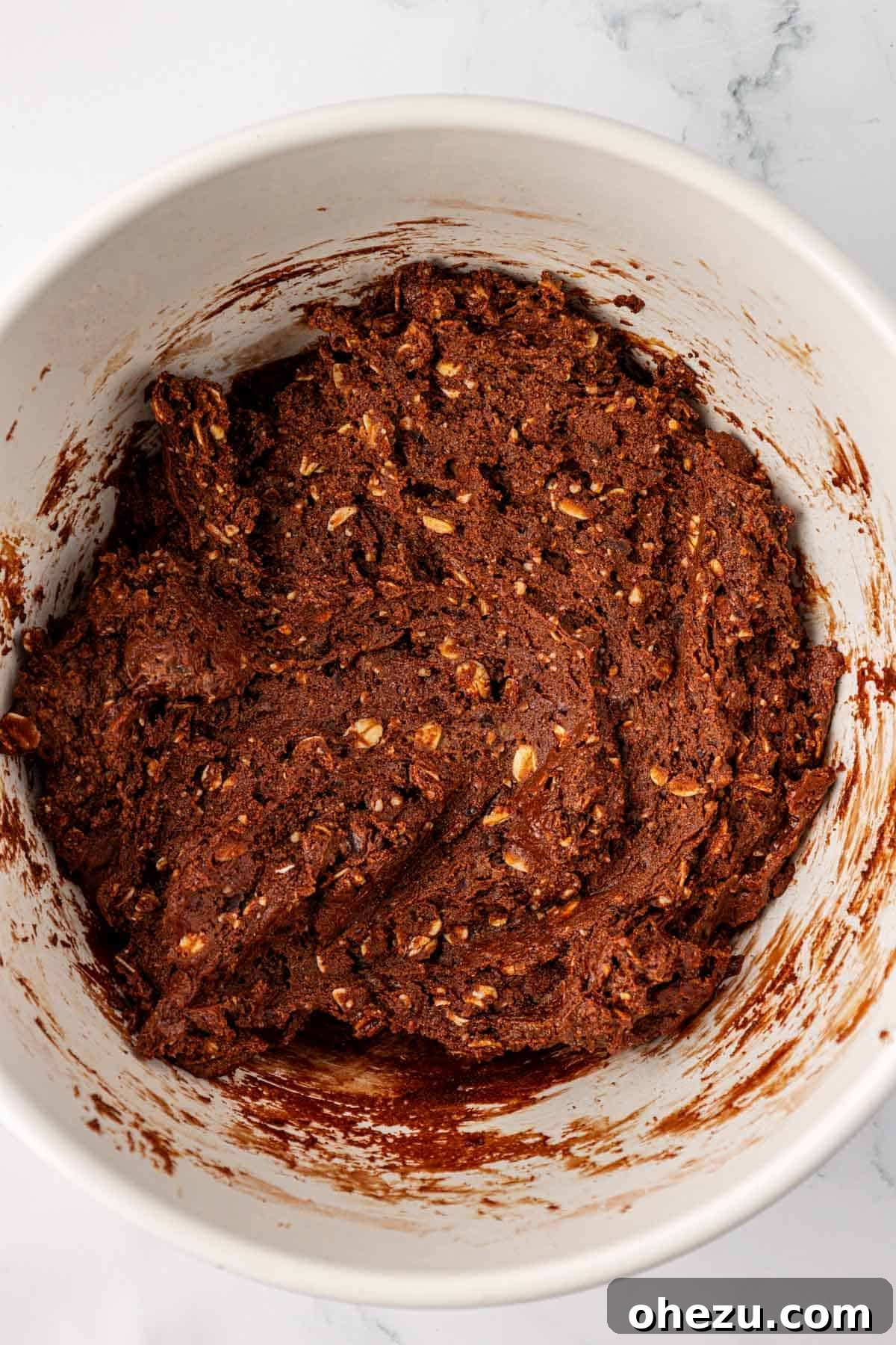 The thick protein bar batter perfectly mixed together in a bowl, ready for pressing