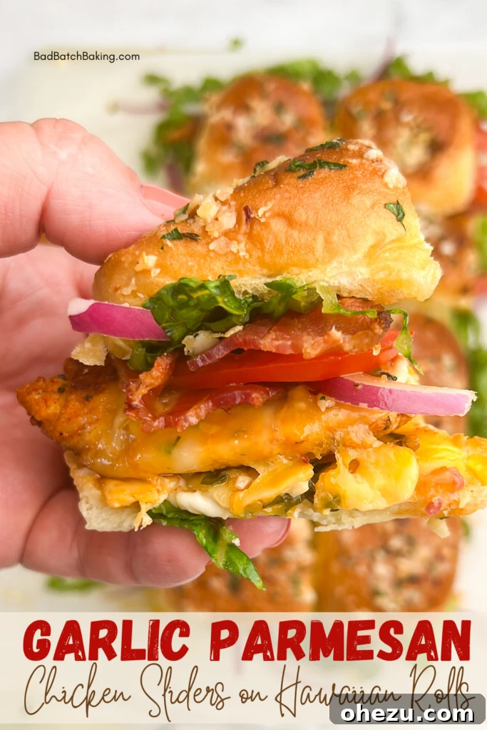 Irresistible Garlic Parmesan Chicken Sliders on Sweet Hawaiian Buns 6 A plate of chicken sliders on Hawaiian rolls with fresh toppings
