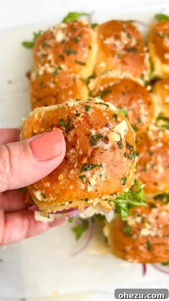 Irresistible Garlic Parmesan Chicken Sliders on Sweet Hawaiian Buns 3 Garlic Parmesan Chicken Sliders on a platter ready to serve