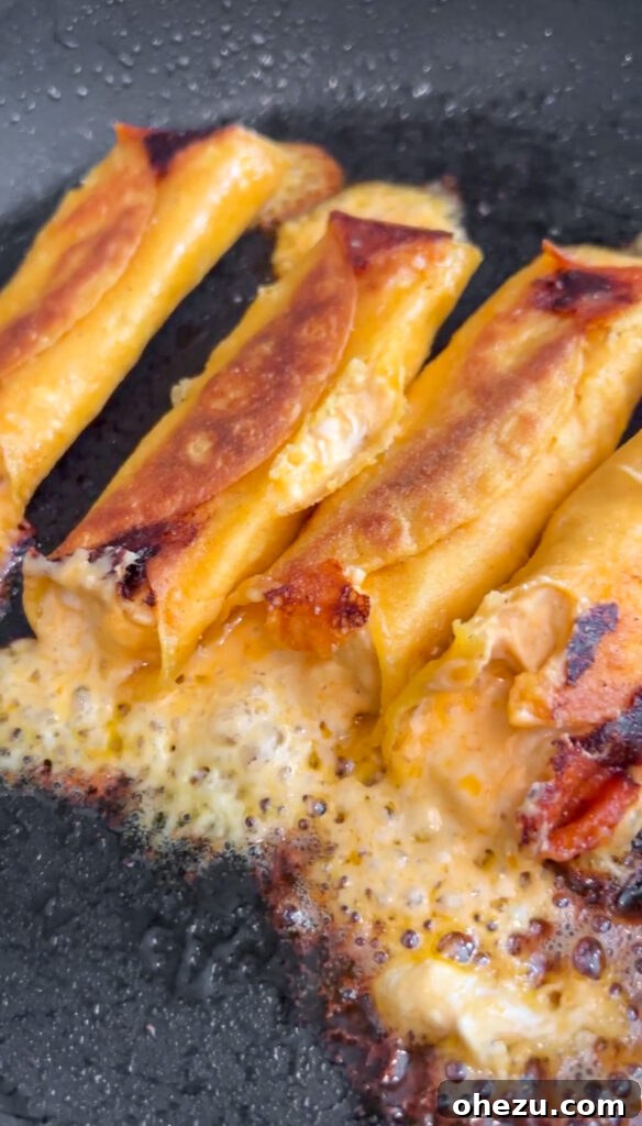 Crispy Buffalo Chicken Taquitos on a wooden board