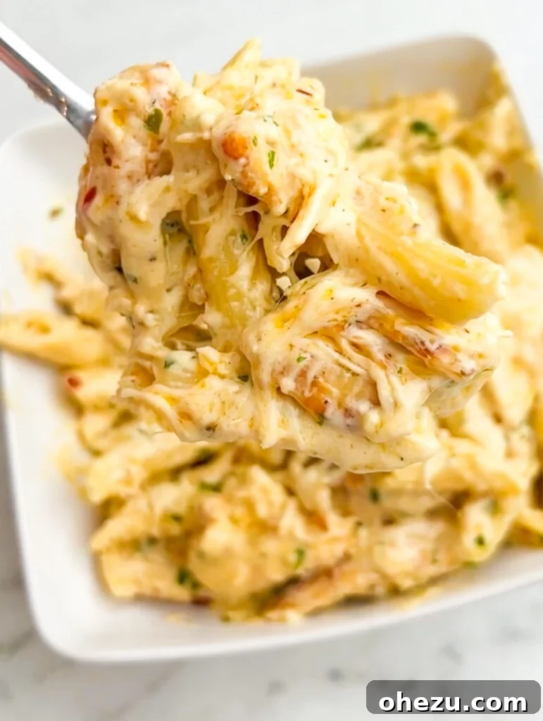 Creamy Garlic Parmesan Chicken Pasta 5 Plated Garlic Parmesan Chicken Pasta garnished with parsley