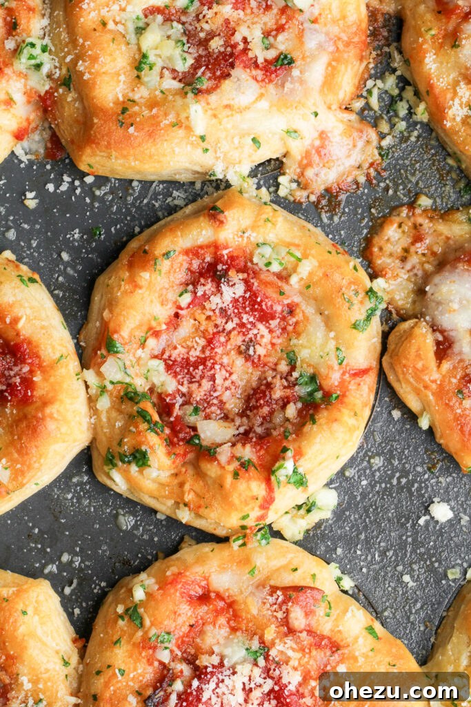 Delicious Mini Deep Dish Pizzas, fresh out of the oven, sprinkled with Parmesan
