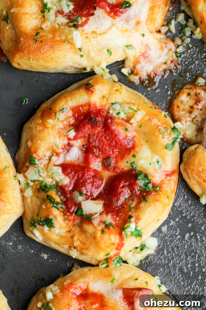 Three Mini Deep Dish Pizzas, golden brown and topped with parmesan