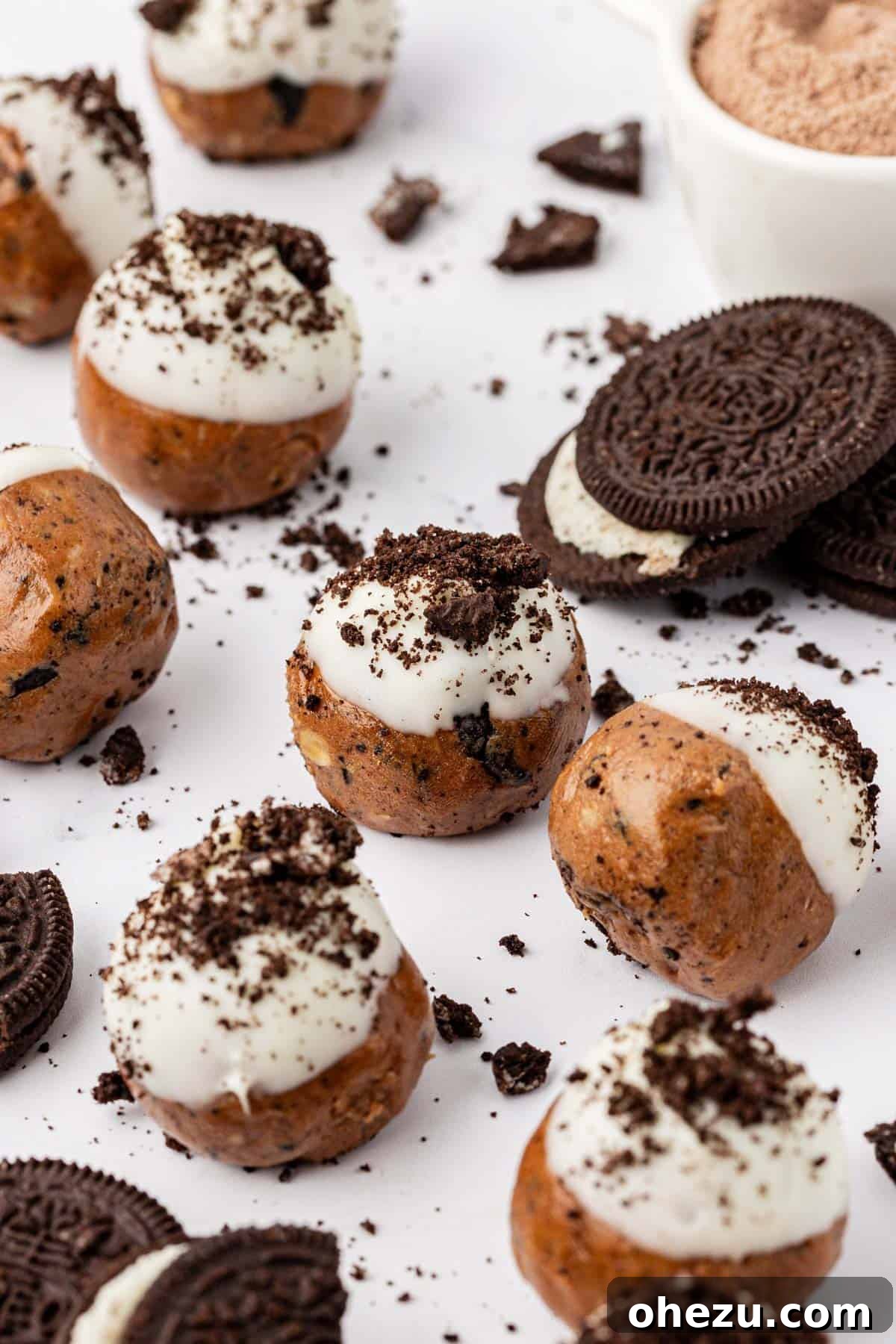 A close-up shot of a stack of cookies and cream protein balls, perfectly layered.