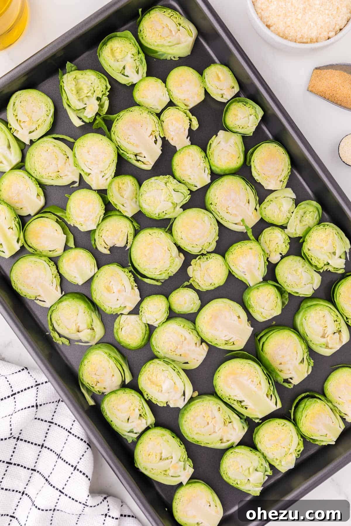Savory Sprout Crisps 6 brussels sprouts slices on a baking sheet, ready for seasoning