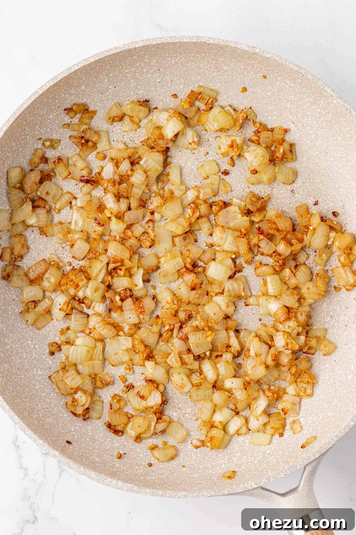 Plant-Powered Breakfast Hash 8 Perfectly cooked and caramelized garlic and onion mixture in a skillet.