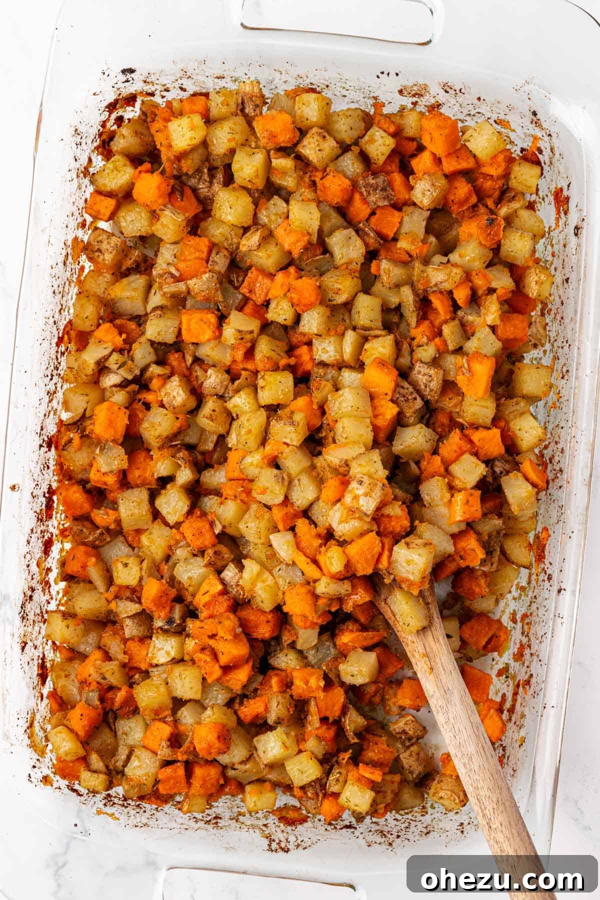 Plant-Powered Breakfast Hash 9 The final vegan breakfast hash, featuring crispy potatoes mixed with caramelized onions and garlic, served fresh from the oven.